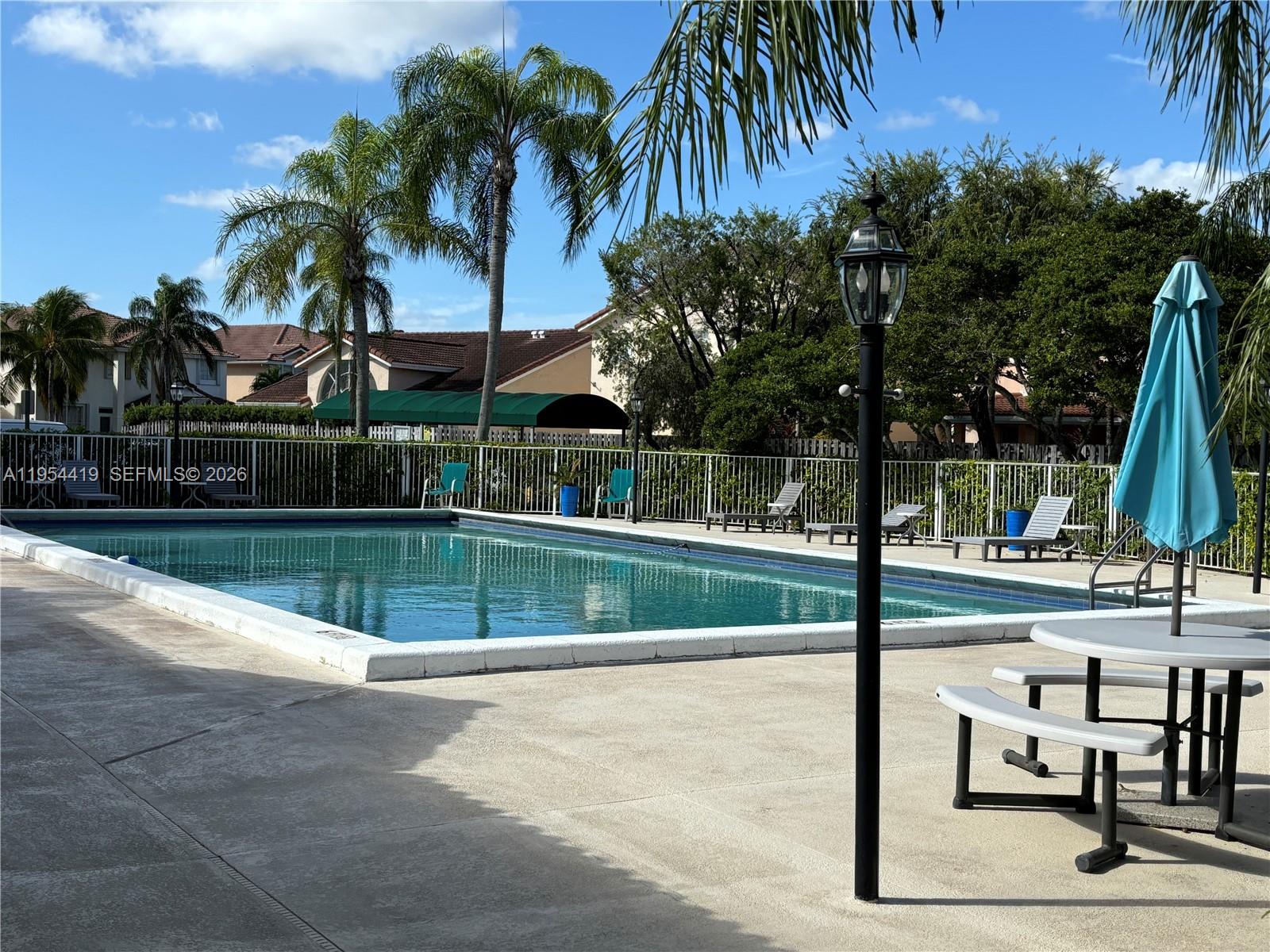 11132 Southwest 153rd Court Miami, FL 33196 - Photo 22 of 33 a view of a swimming pool with a table and chairs