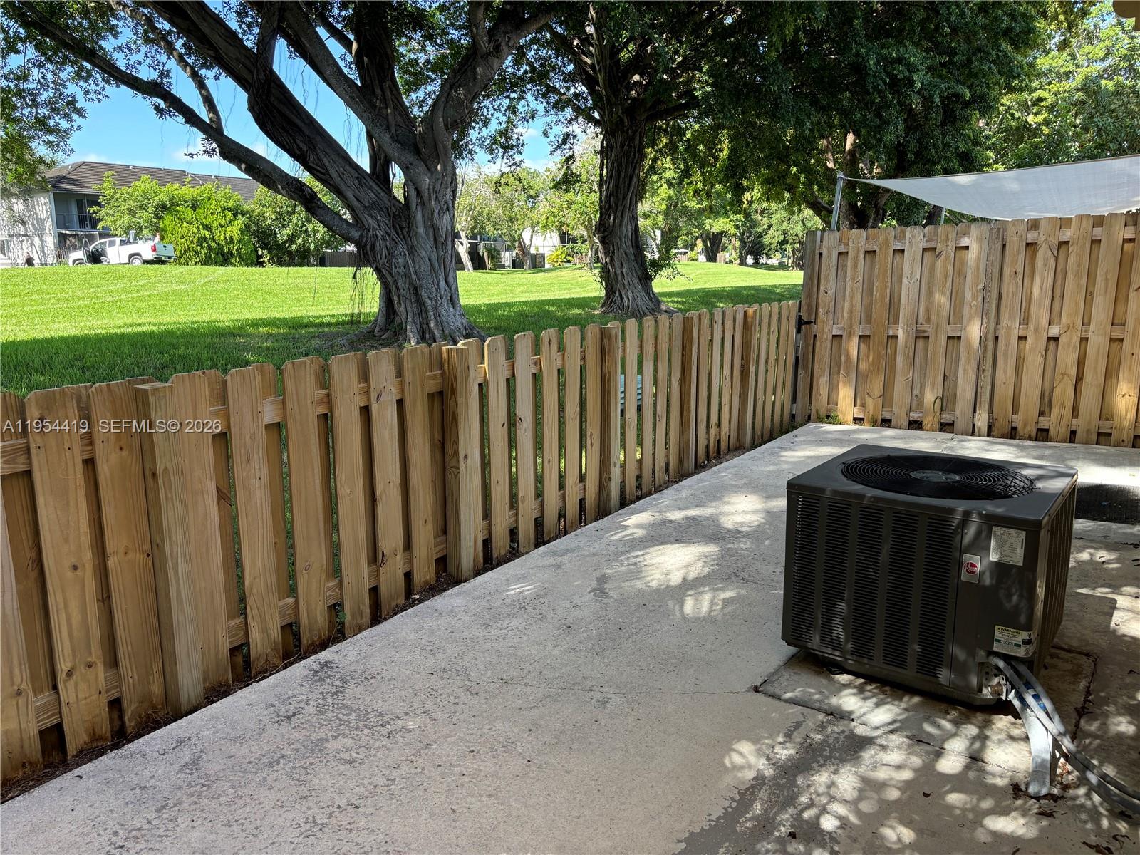 11132 Southwest 153rd Court Miami, FL 33196 - Photo 7 of 33 a view of a backyard with wooden fence and a large tree