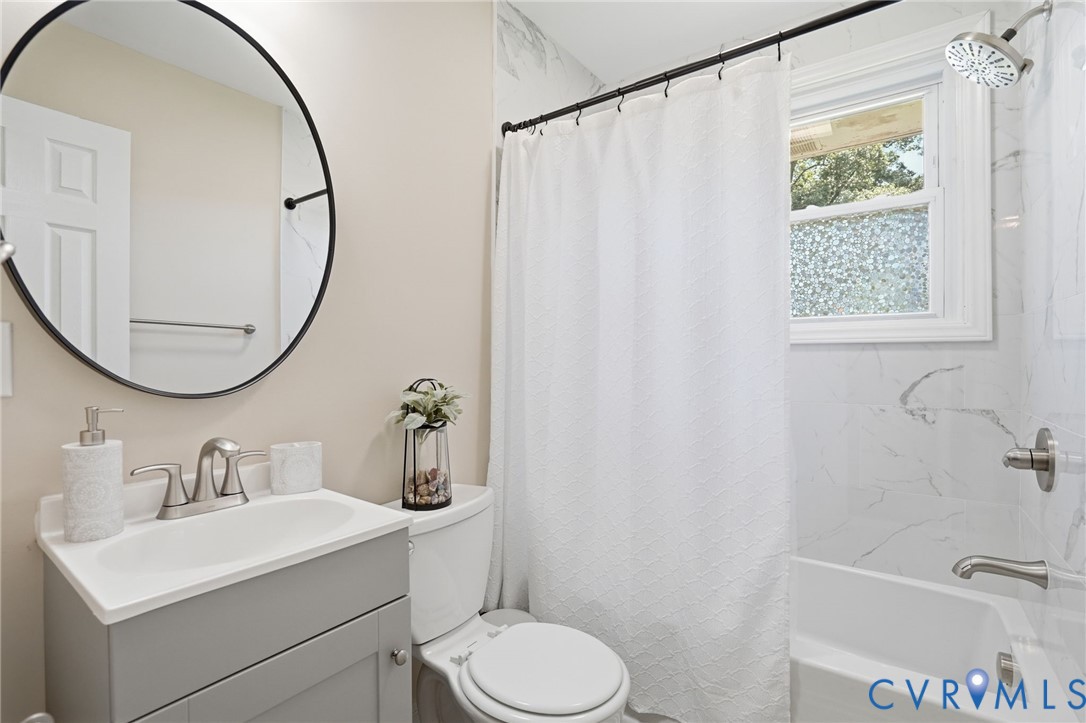 2403 Omega Road Henrico, VA 23228 - Photo 18 of 39 a bathroom with a sink a toilet and a mirror