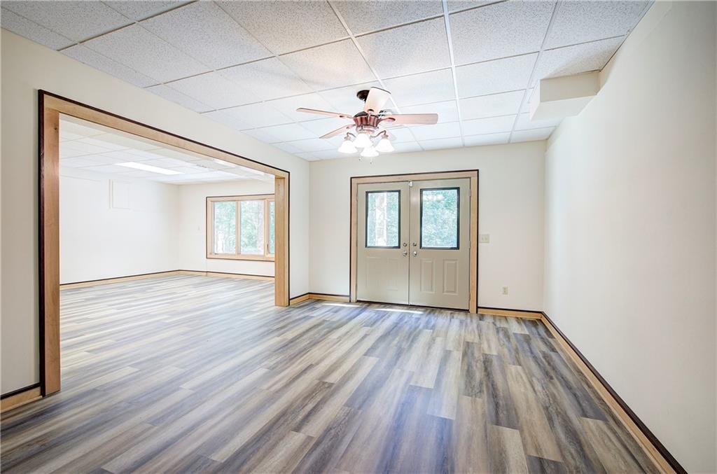 260 Road 2 S Southwest Cartersville, GA 30120 - Photo 46 of 69 an empty room with wooden floor chandelier fan and windows