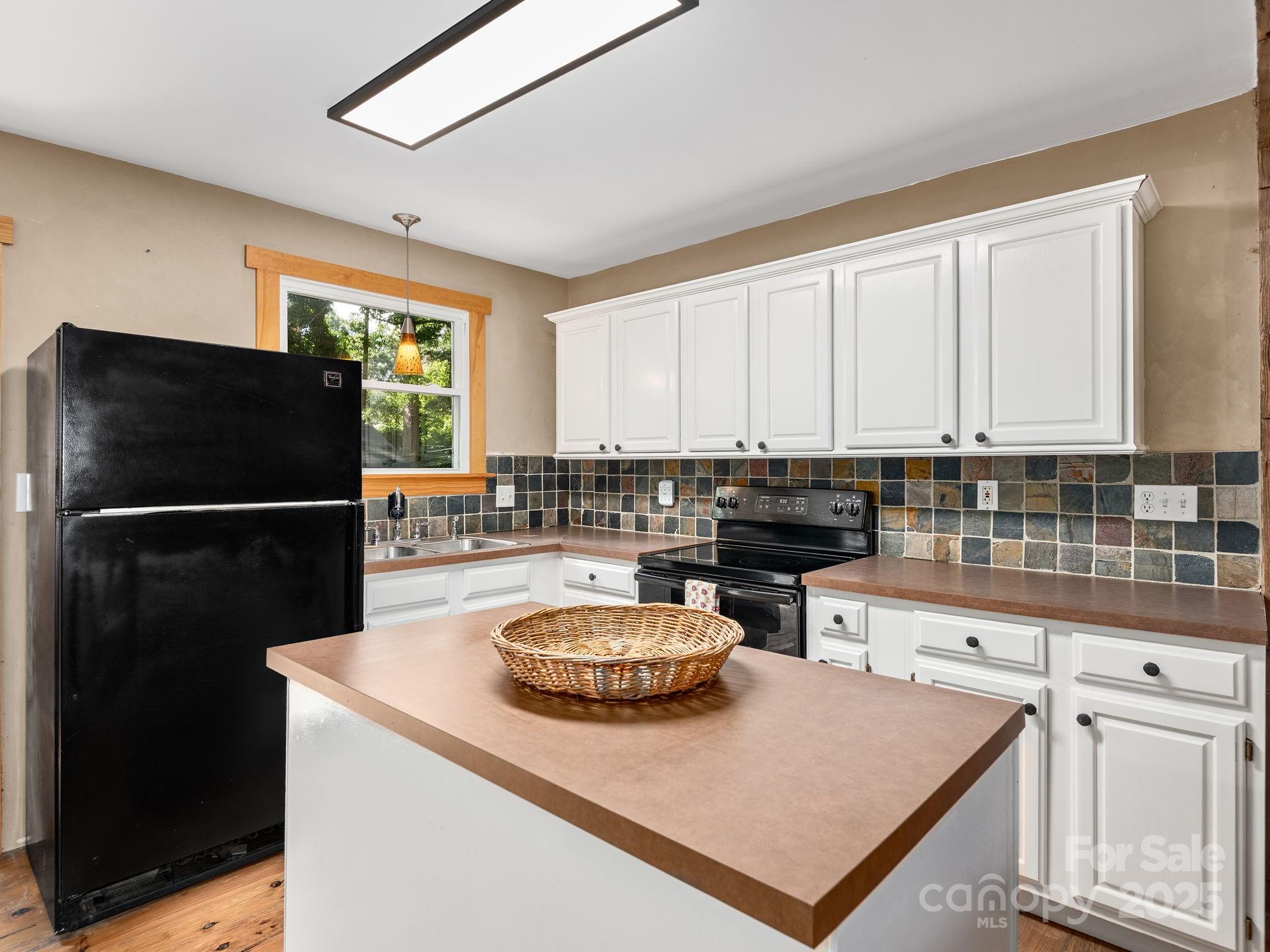 915 Tunnel Road Asheville, NC 28805 - Photo 7 of 22 a kitchen with a refrigerator and a sink