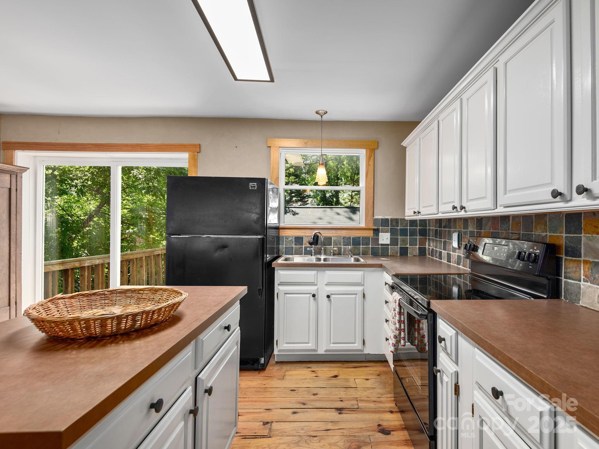 915 Tunnel Road Asheville, NC 28805 - Photo 8 of 22 a kitchen with a sink stove and refrigerator