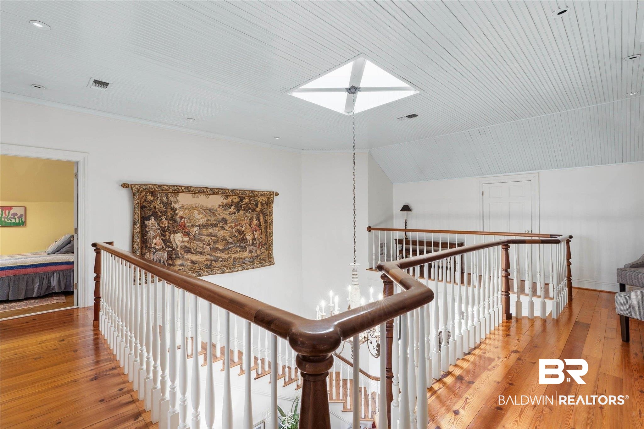 3500 Higgins Road Mobile, AL 36619 - Photo 31 of 54 Hallway featuring wood-type flooring, vaulted ceiling, an upstairs landing, and a skylight