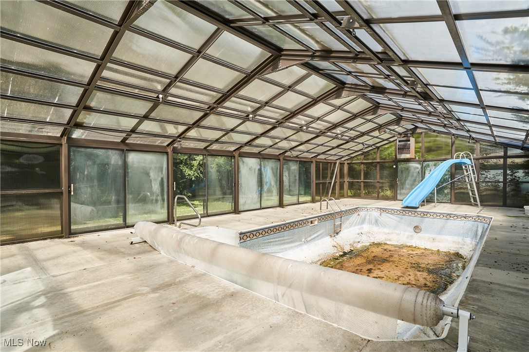 11715 Dunham Road Northfield, OH 44067 - Photo 5 of 19 View of swimming pool with a water slide and a hot tub