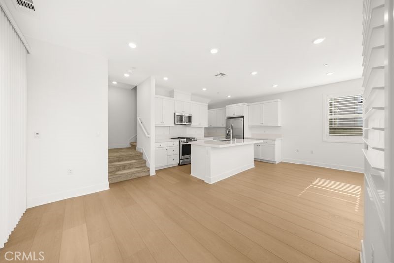 112 Junco Irvine, CA 92618 - Photo 4 of 17 a view of a kitchen with furniture and refrigerator