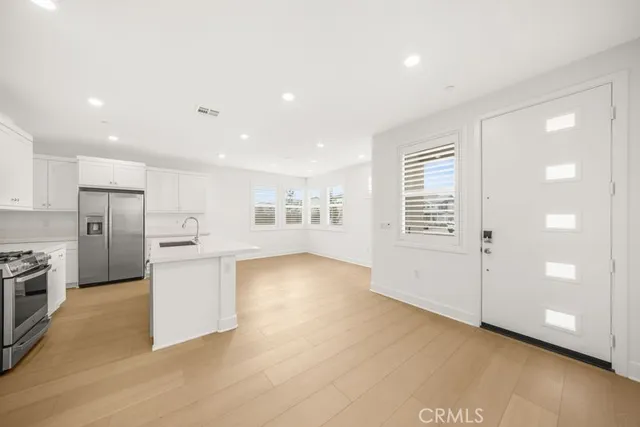 a kitchen with stainless steel appliances a refrigerator and a sink