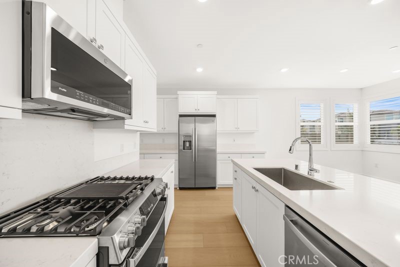 112 Junco Irvine, CA 92618 - Photo 7 of 17 a kitchen with stainless steel appliances a sink a stove and a microwave