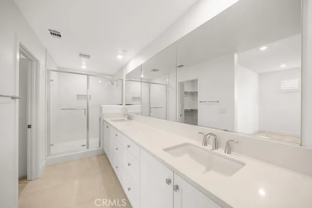 a large bathroom with a double vanity sink and mirror