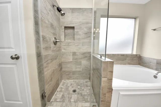 a bathroom with a bathtub and a shower