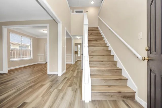 a view of an entryway with wooden floor and stairs