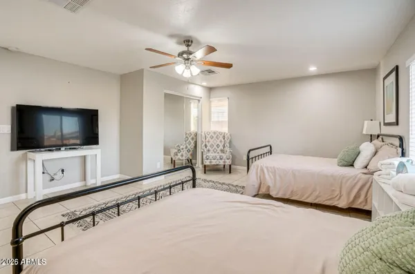 a bedroom with a bed and a flat screen tv