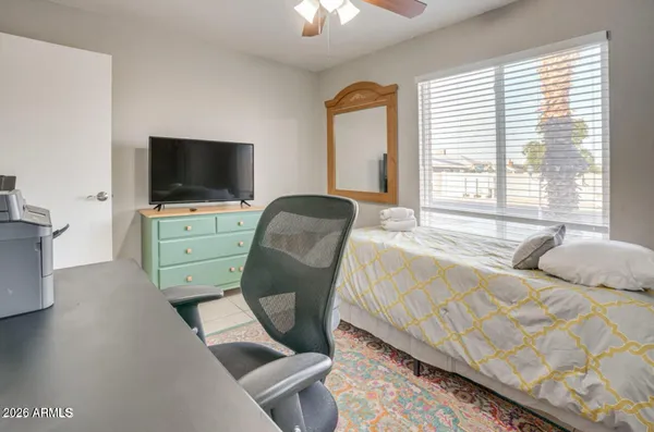 a bedroom with furniture and a flat screen tv
