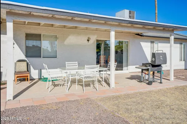 a view of a patio with table and chairs