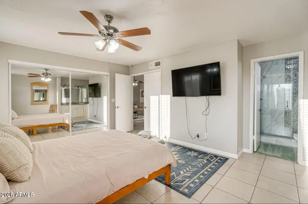 a bedroom with a bed and a flat screen tv