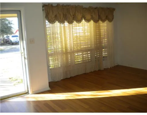 a view of a bathroom with a window and a shower curtain