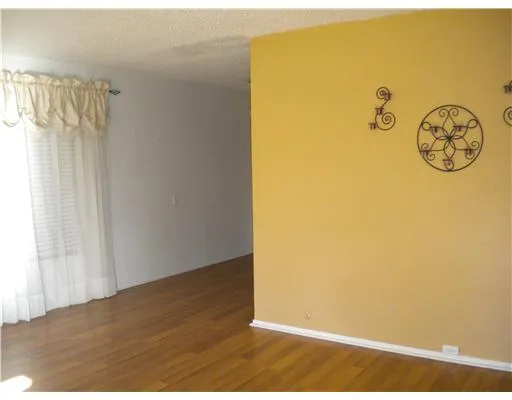 a kitchen with granite countertop a white refrigerator stove a sink and dishwasher