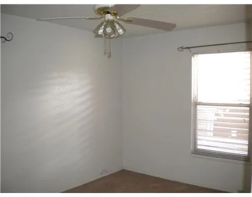 a bathroom with a glass shower door and a window