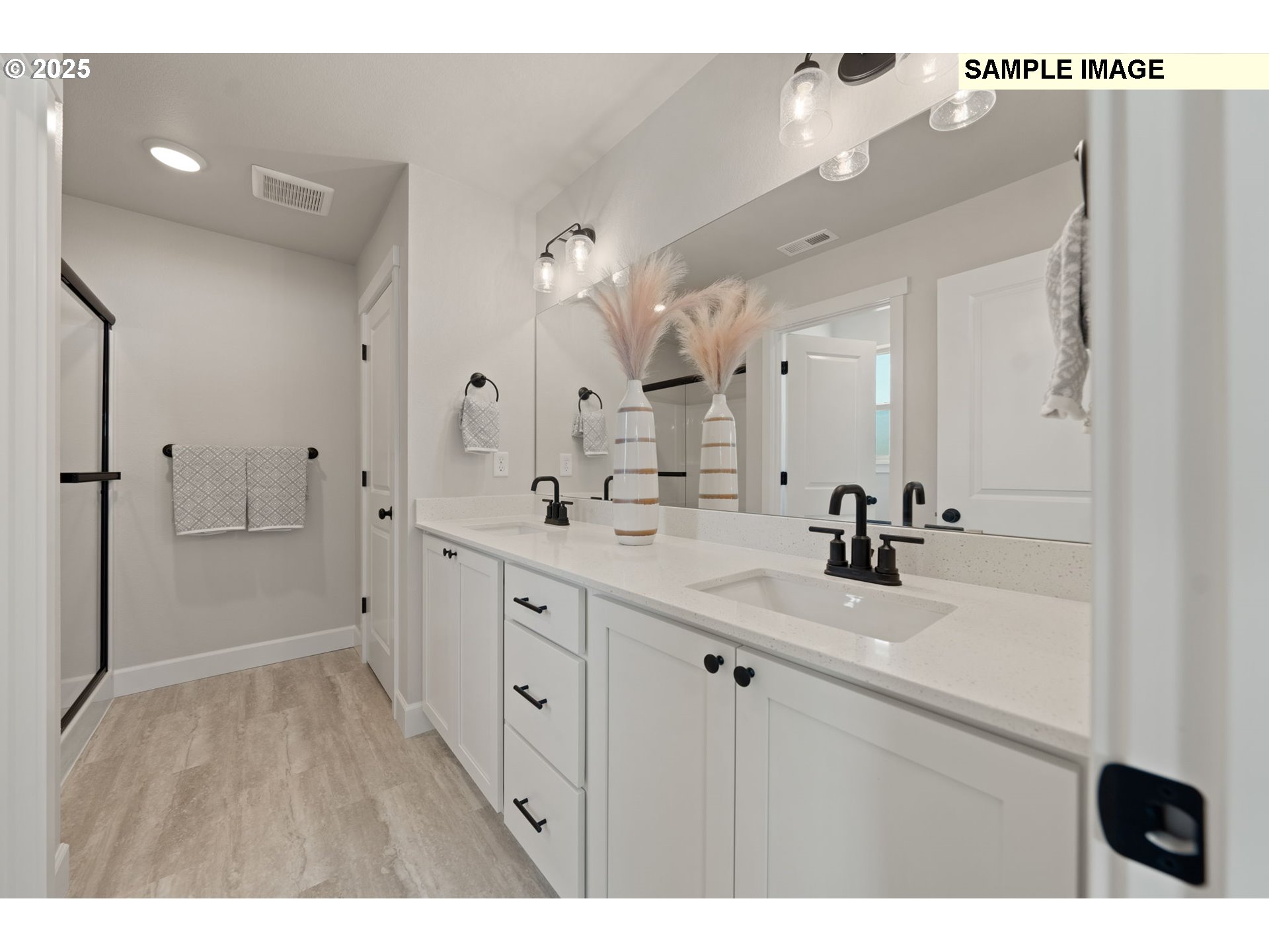 562 Taft Street Umatilla, OR 97882 - Photo 22 of 28 a bathroom with a double vanity sink mirror and shower