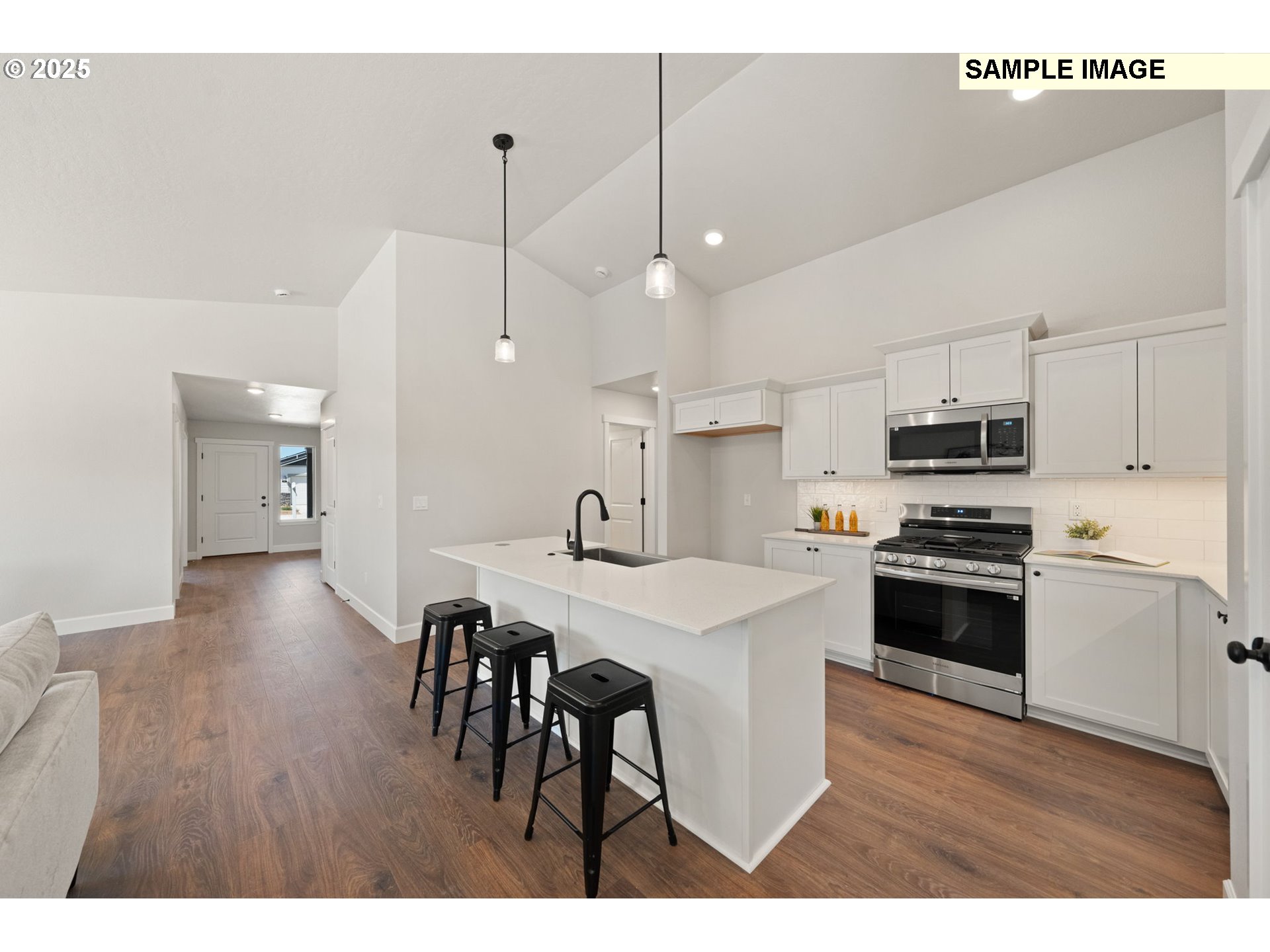 562 Taft Street Umatilla, OR 97882 - Photo 10 of 28 a open kitchen with stainless steel appliances granite countertop a stove a refrigerator a kitchen island a sink and a oven