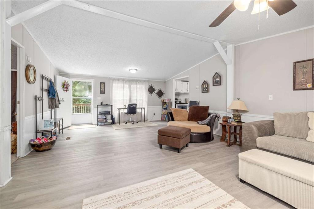 126 Loggins Trail Commerce, GA 30529 - Photo 11 of 50 a living room with furniture and a flat screen tv