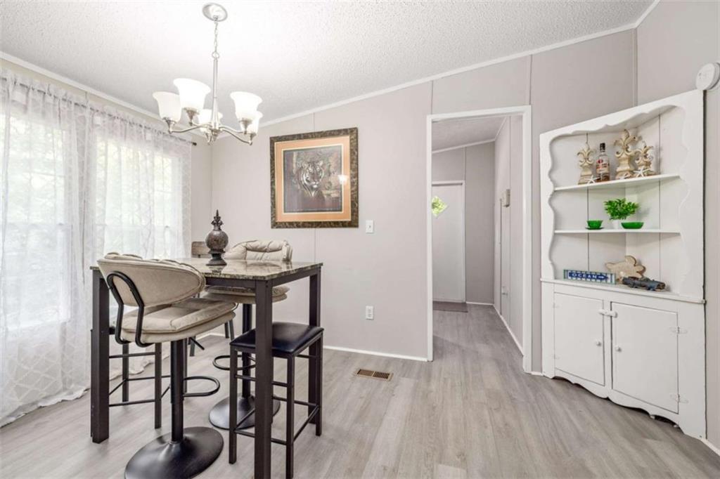 126 Loggins Trail Commerce, GA 30529 - Photo 17 of 50 a view of a dining room with furniture window and wooden floor