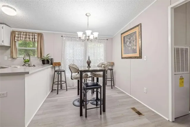 a view of a dining room with furniture and window