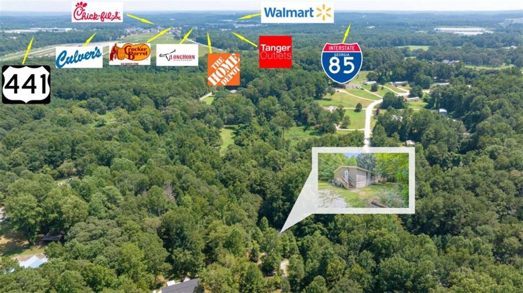 126 Loggins Trail Commerce, GA 30529 - Photo 3 of 50 a sign that is sitting on a brick wall