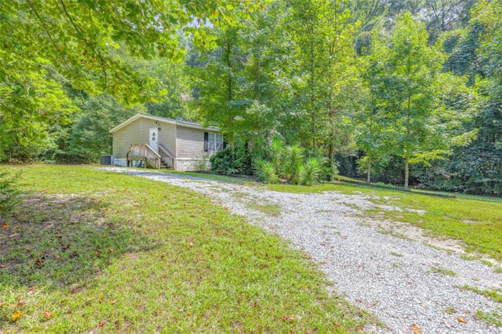 126 Loggins Trail Commerce, GA 30529 - Photo 33 of 50 a backyard of a house with yard and trampoline