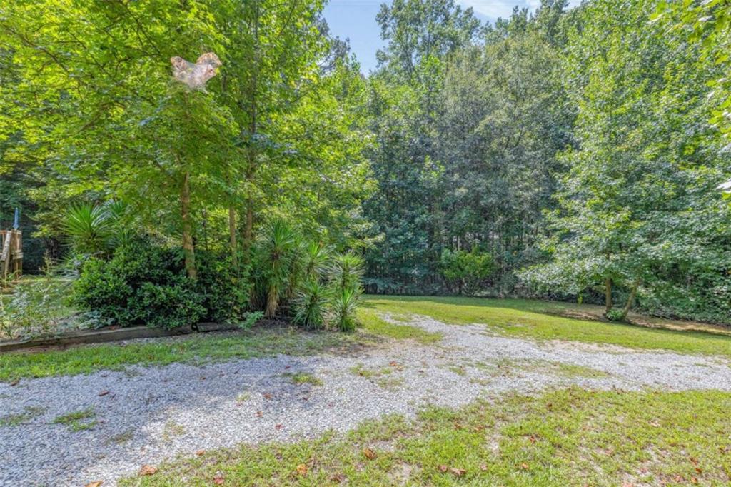 126 Loggins Trail Commerce, GA 30529 - Photo 35 of 50 a view of a swimming pool with a yard and large trees