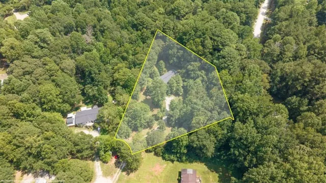 a backyard of a house with lots of trees