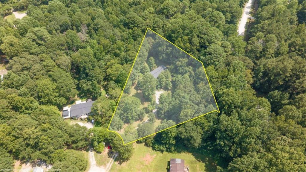 126 Loggins Trail Commerce, GA 30529 - Photo 39 of 50 a backyard of a house with lots of trees