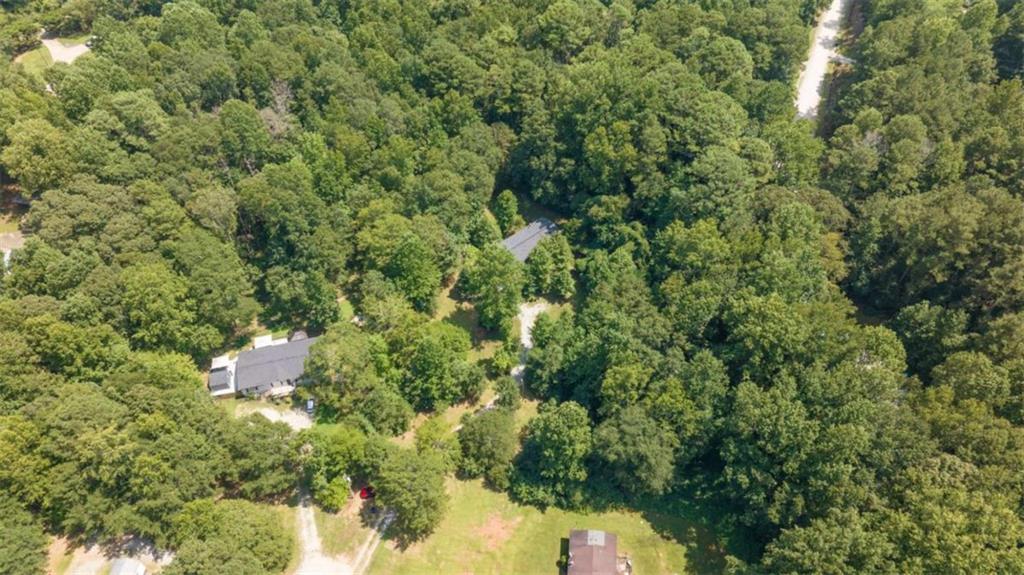 126 Loggins Trail Commerce, GA 30529 - Photo 40 of 50 a view of a house with a lush green forest