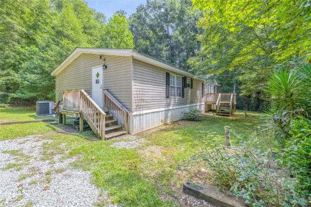 a view of a house with a yard and sitting area
