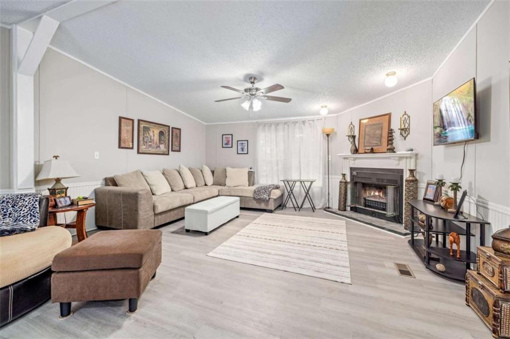 126 Loggins Trail Commerce, GA 30529 - Photo 10 of 50 a living room with furniture and a fireplace