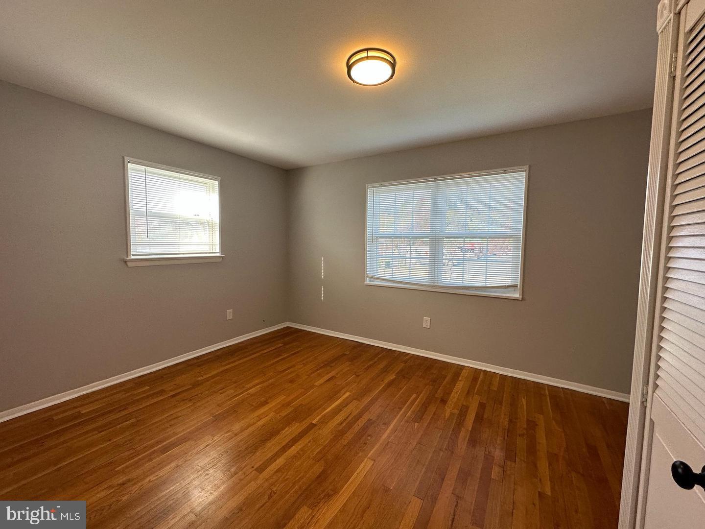 4116 Duke Street Alexandria, VA 22304 - Photo 13 of 16 an empty room with wooden floor and windows