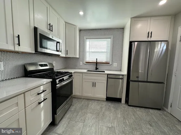 a kitchen with a refrigerator sink and microwave