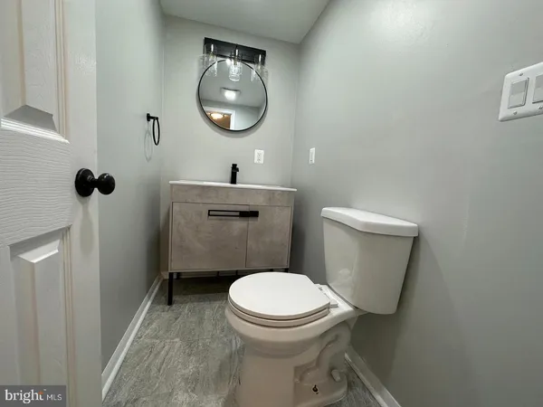 a bathroom with a toilet and a mirror