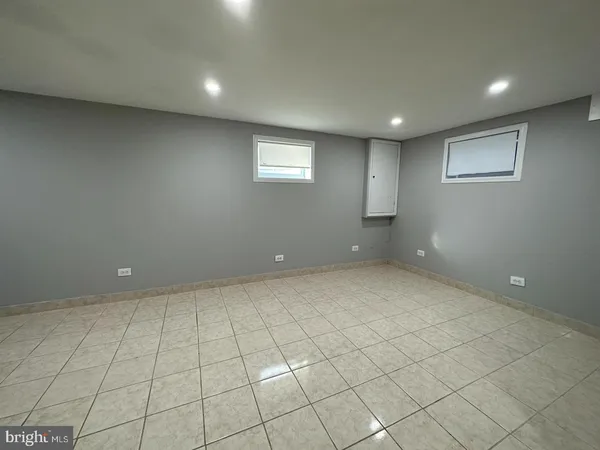an empty room with white walls and tiles