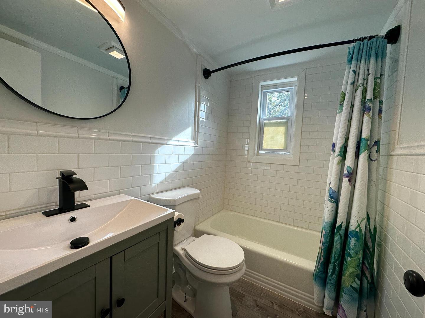 4116 Duke Street Alexandria, VA 22304 - Photo 10 of 16 a bathroom with a sink toilet and shower