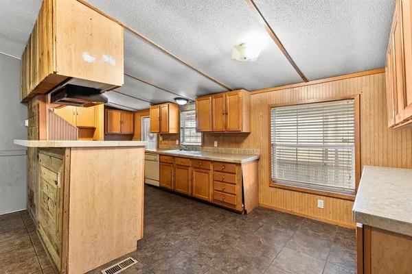 a kitchen with sink cabinets and window