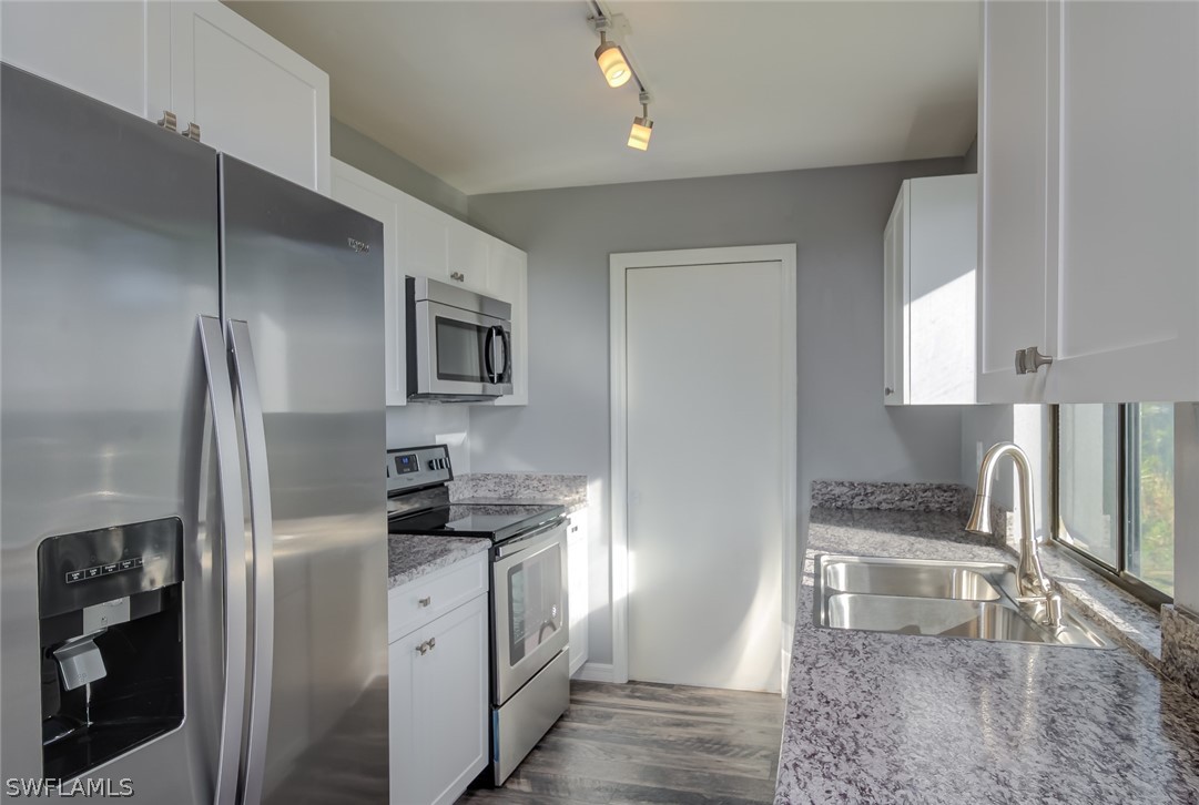 18485 Sebring Road Fort Myers, FL 33967 - Photo 1 of 21 a kitchen with a refrigerator sink and stove