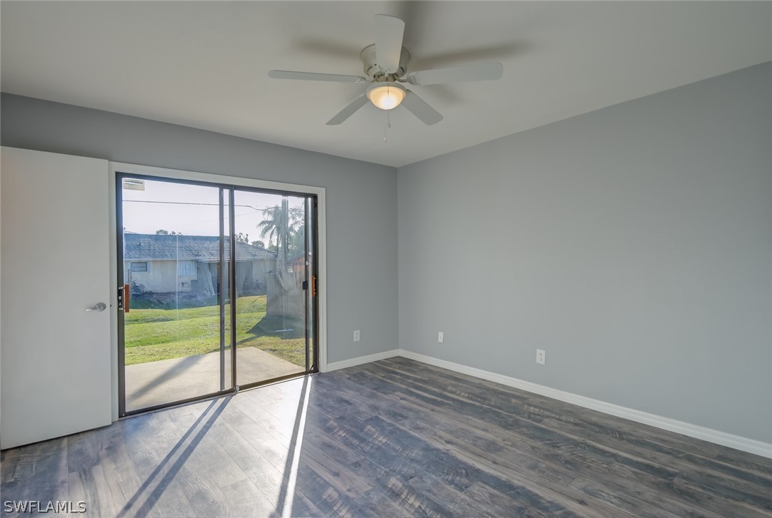18485 Sebring Road Fort Myers, FL 33967 - Photo 12 of 21 wooden floor in an empty room with a window