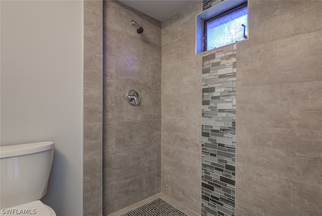 18485 Sebring Road Fort Myers, FL 33967 - Photo 15 of 21 a bathroom with a shower and a toilet