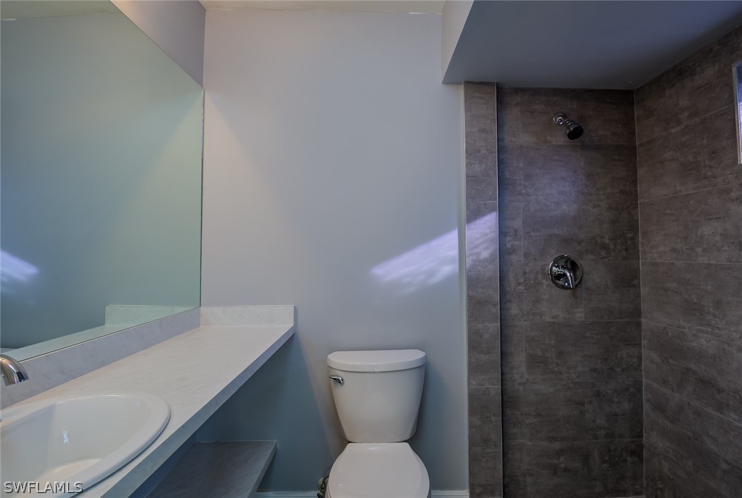 18485 Sebring Road Fort Myers, FL 33967 - Photo 16 of 21 a bathroom with a sink a toilet and shower