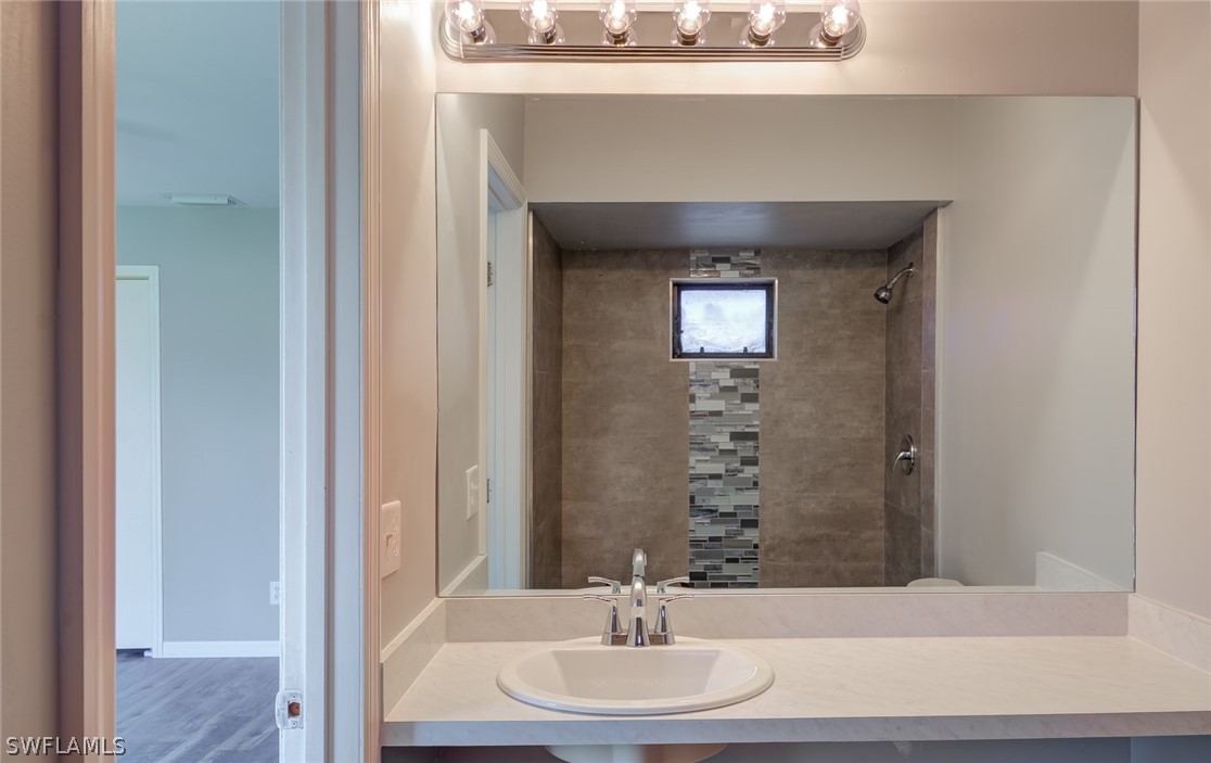 18485 Sebring Road Fort Myers, FL 33967 - Photo 17 of 21 a bathroom with a sink and a mirror