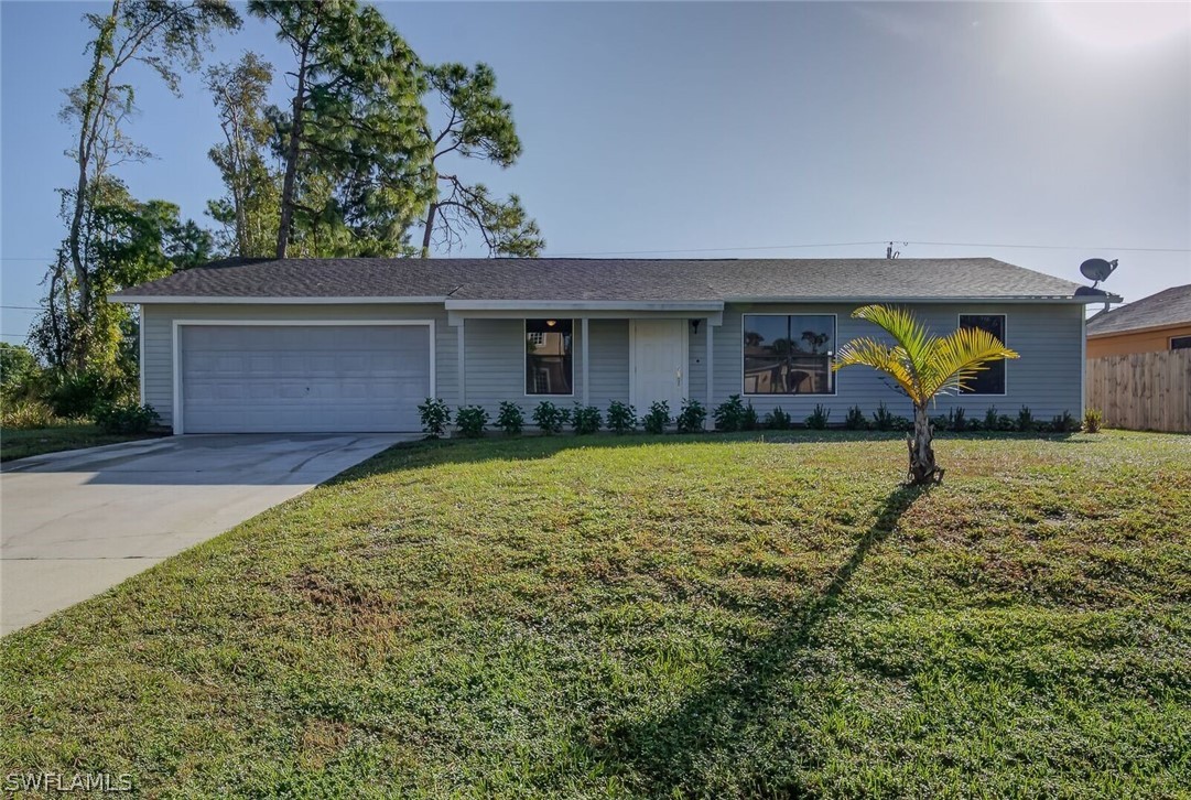 18485 Sebring Road Fort Myers, FL 33967 - Photo 2 of 21 a front view of house with yard and trees in the background