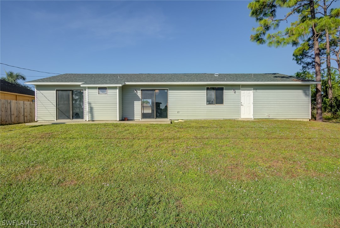 18485 Sebring Road Fort Myers, FL 33967 - Photo 21 of 21 a front view of house with yard and trees in the background