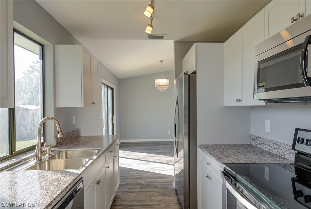 18485 Sebring Road Fort Myers, FL 33967 - Photo 3 of 21 a kitchen with stainless steel appliances granite countertop a sink stove and refrigerator