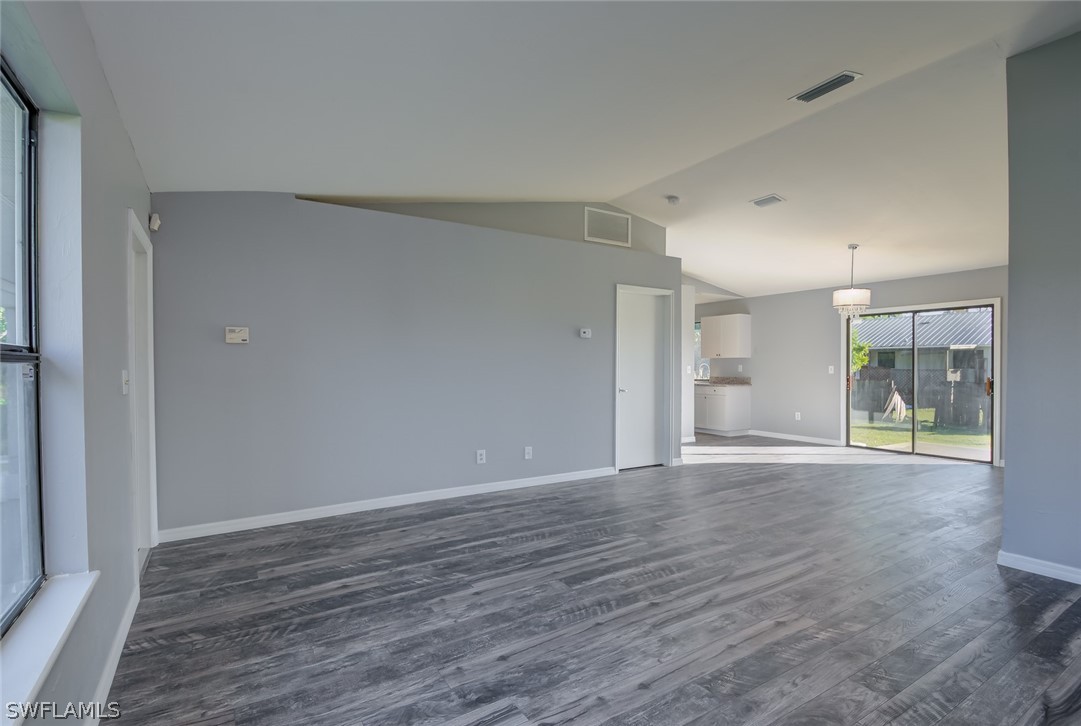 18485 Sebring Road Fort Myers, FL 33967 - Photo 4 of 21 a view of an empty room with wooden floor and a window