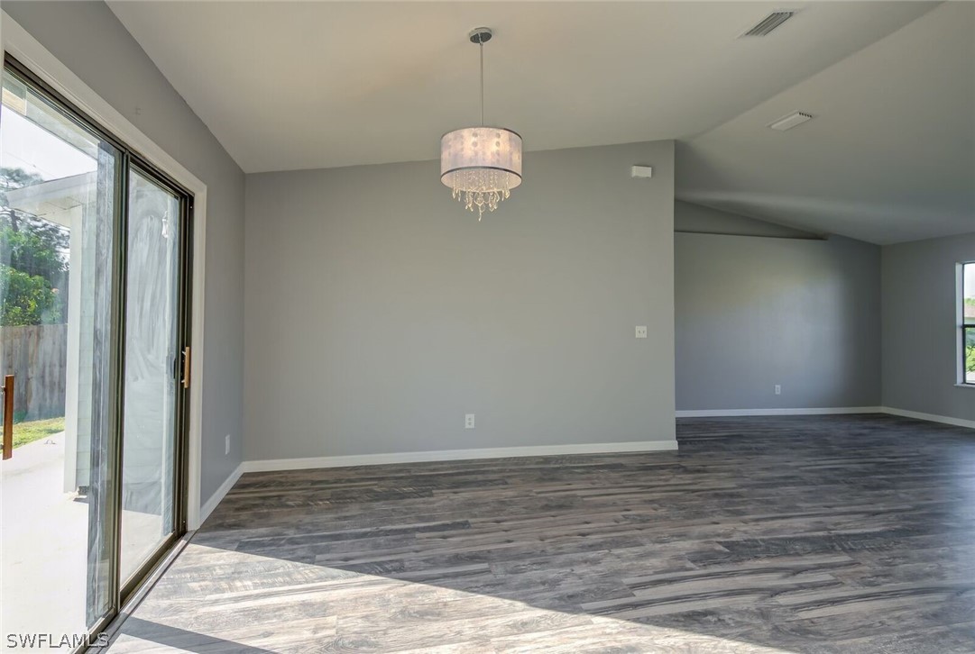 18485 Sebring Road Fort Myers, FL 33967 - Photo 5 of 21 a view of an empty room with wooden floor and a window